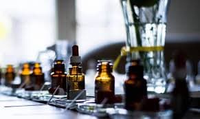 Exquisite raw perfume ingredients displayed in glass vials and golden containers