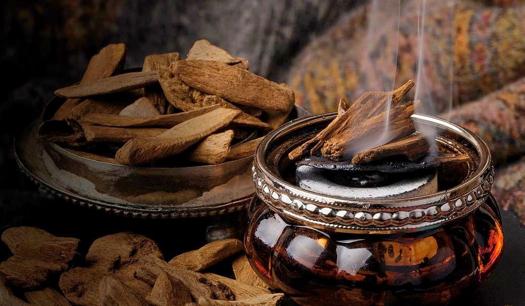 Precious oud wood chips and oil in traditional Middle Eastern setting